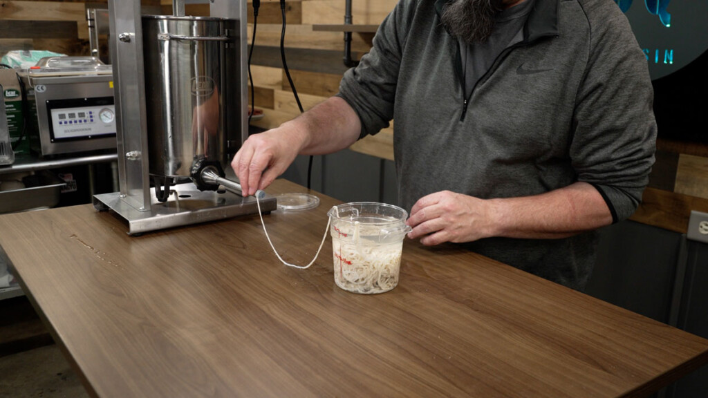 attaching sheep casing to sausage stuffer