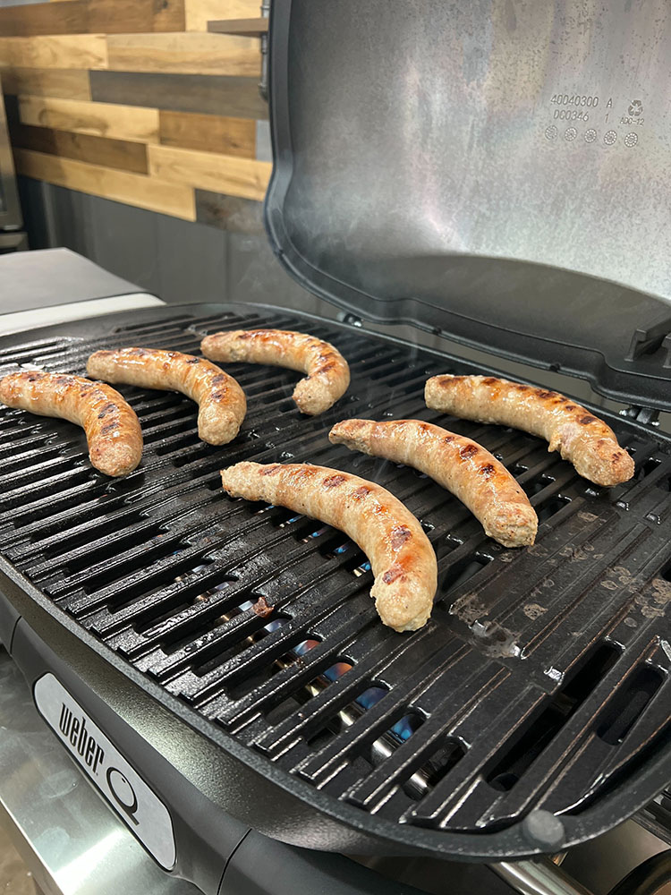 grilling breakfast sausage on the weber kettle