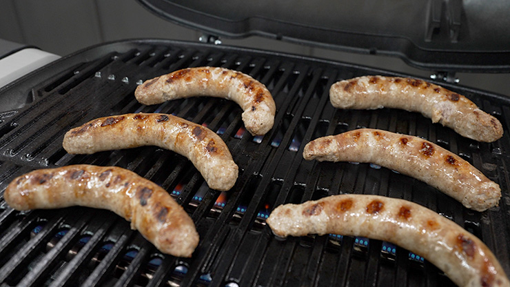 Homemade breakfast brats cooking on the Weber Q Plus gas grill