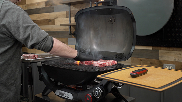 ribeye steaks cooking on a Weber Q 2800N Plus gas grill