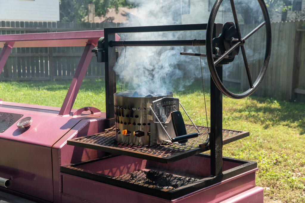 santa maria grill with a charcoal chimney start on top smoking