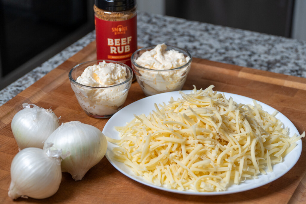 smoked onion dip ingredients on a wooden board