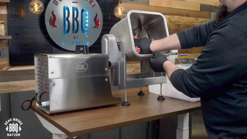stuffing raw ground meat into barrel