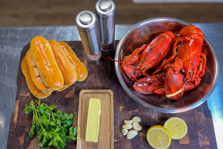 lobster roll ingredients laid out on a wooden board