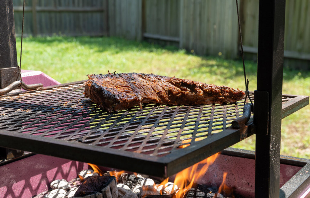 tri-tip on the Santa maria grill with flames underneath