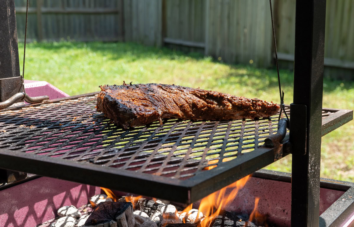tri-tip on the Santa maria grill with flames underneath