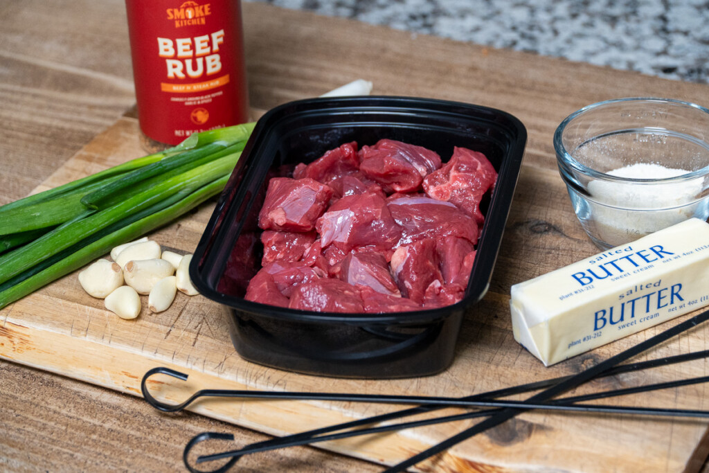 grilled garlic parmesan steak ingredients laid ou on a wooden board