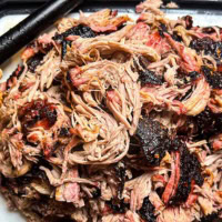 Tender, smoky pulled pork with crispy bark, freshly shredded and ready to serve. Click for the best pulled pork recipes.
