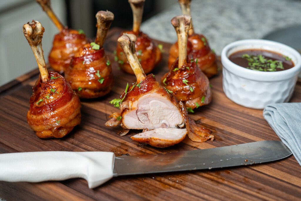 lollipop chicken on a wooden board, one has been sliced