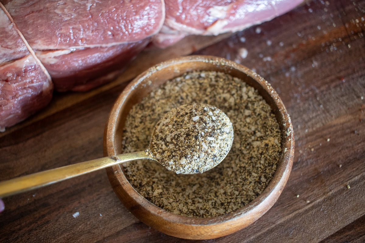 a bowl of steak seasoning with a spoonful in the middle of the picture