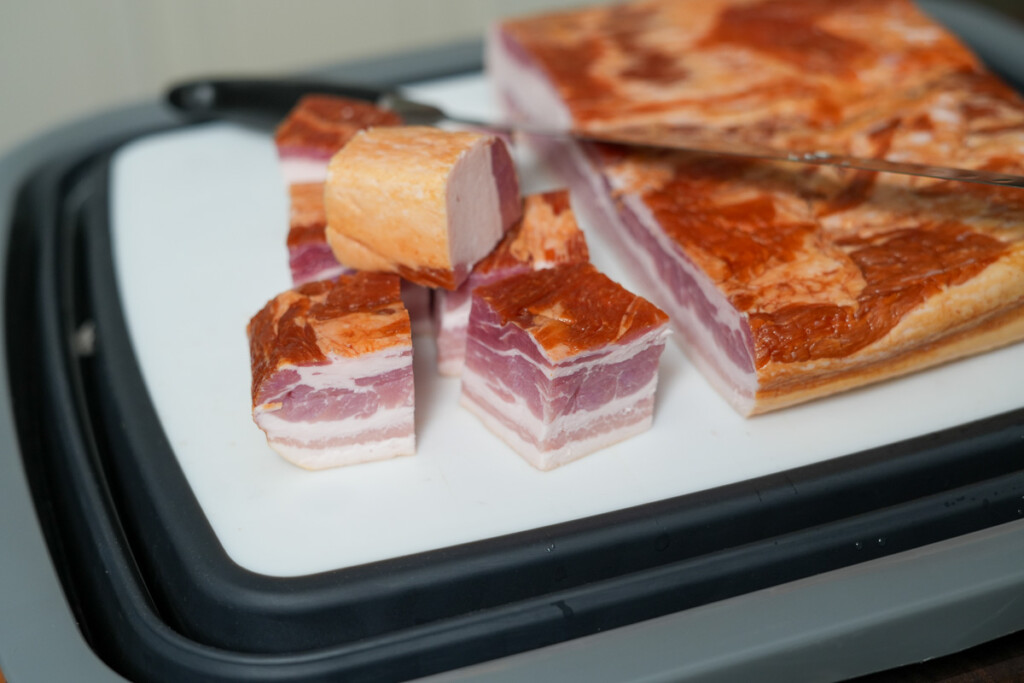 cubes of bacon cut from the slab