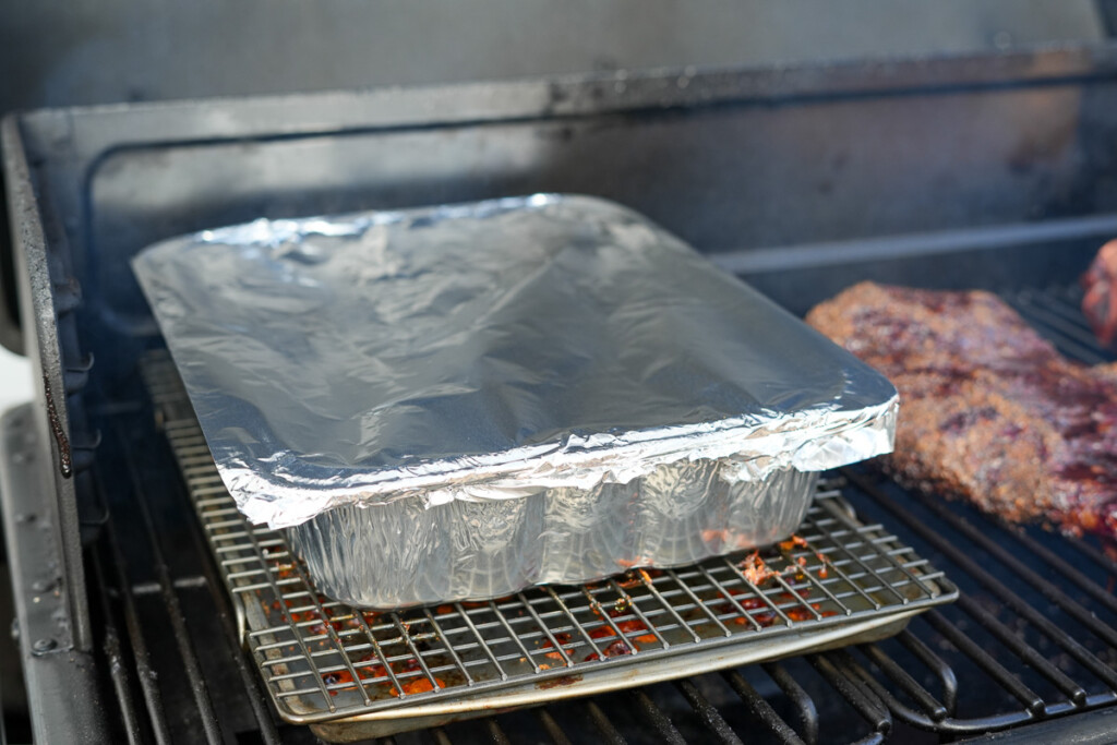 a foil cover aluminum tray in the smoker