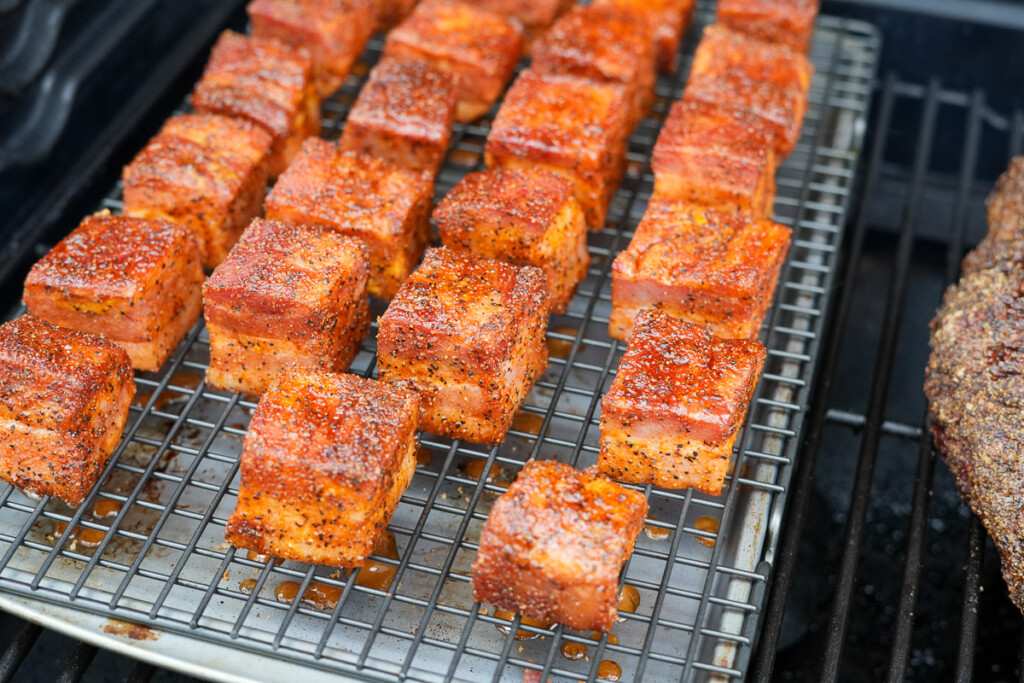 bacon burnt ends on a rack in the smoker