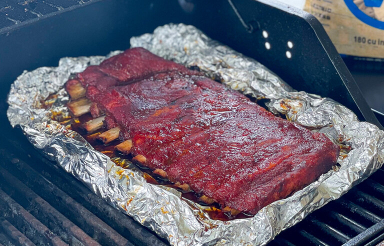 a rack of cooked ribs in foil