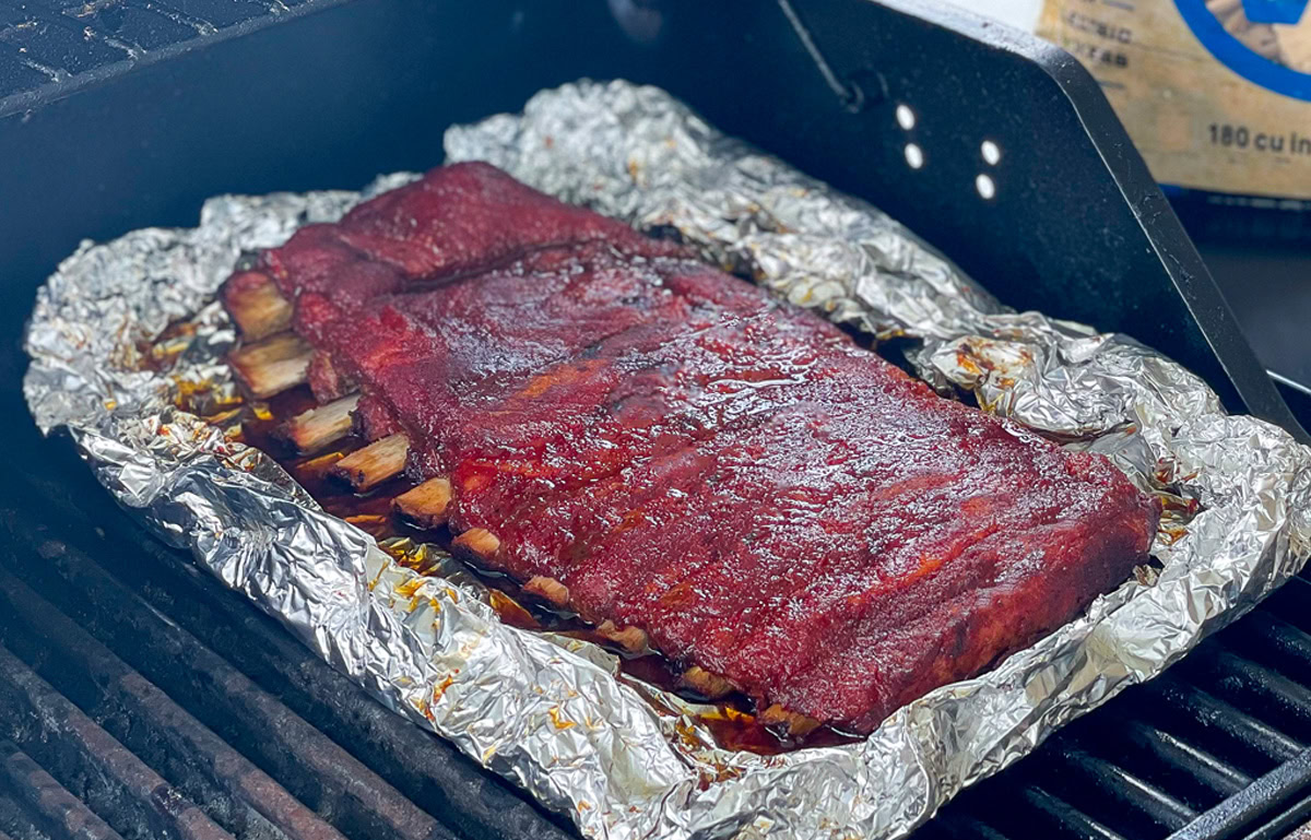 a rack of cooked ribs in foil