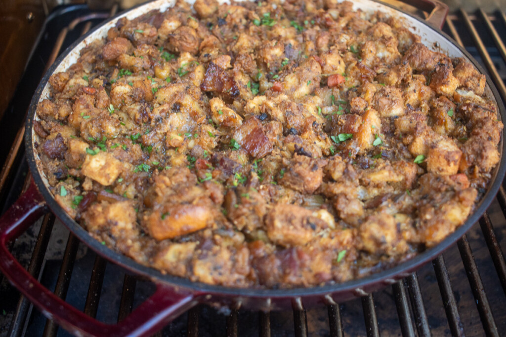 a casserole dish of smoked stuffing in the smoker