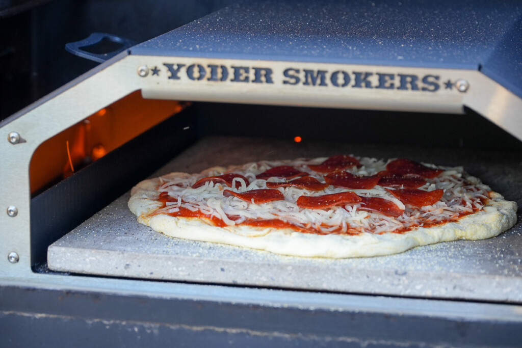 uncooked pizza in pizza oven
