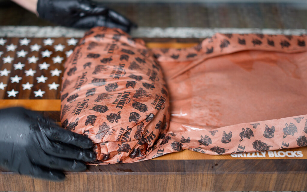 step four wrapping a brisket in pink butcher paper
