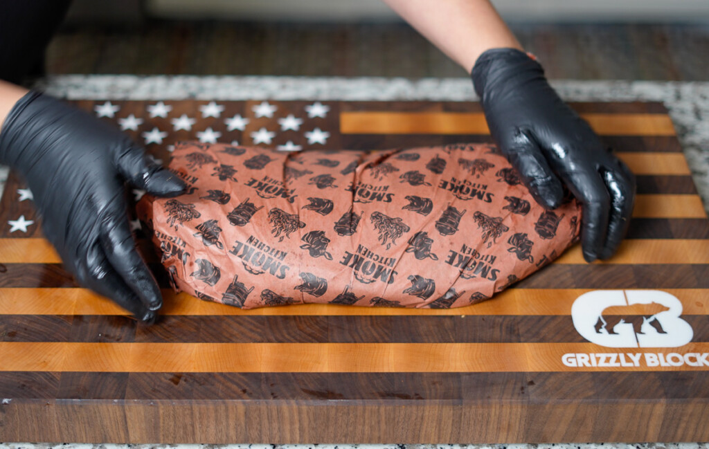 a brisket wrapped in pink butcher paper
