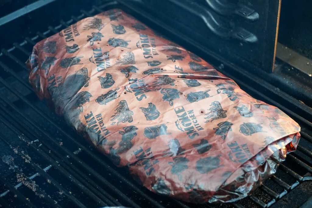 a wrapped brisket in the smoker after two hours