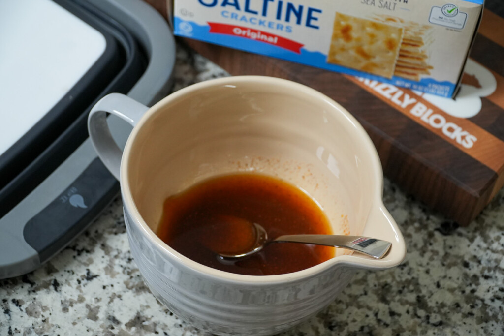oil and seasoning mixed together in a ceramic jug