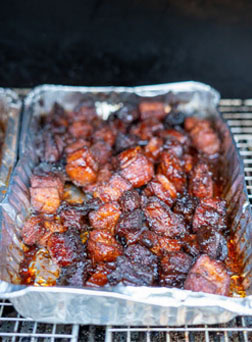 tray of smoked pork belly burnt ends on a pellet grill
