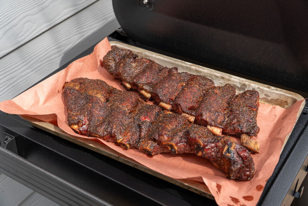two slabs of beef back ribs on pink butcher paper