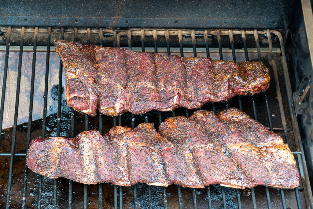 two cooked slabs of beef back ribs in the smoker