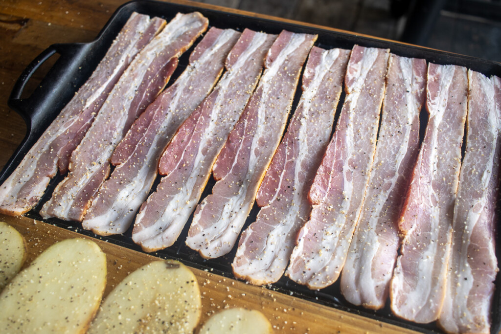 strips of seasoned raw bacon lined up