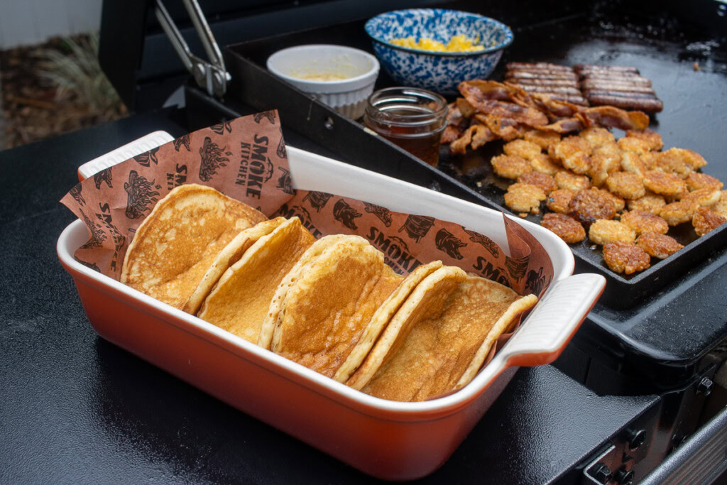 pancakes folded like tacos in a high sided red dish with butcher paper lining it