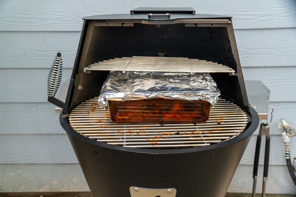 the H-cambro covered in foil in the smoker