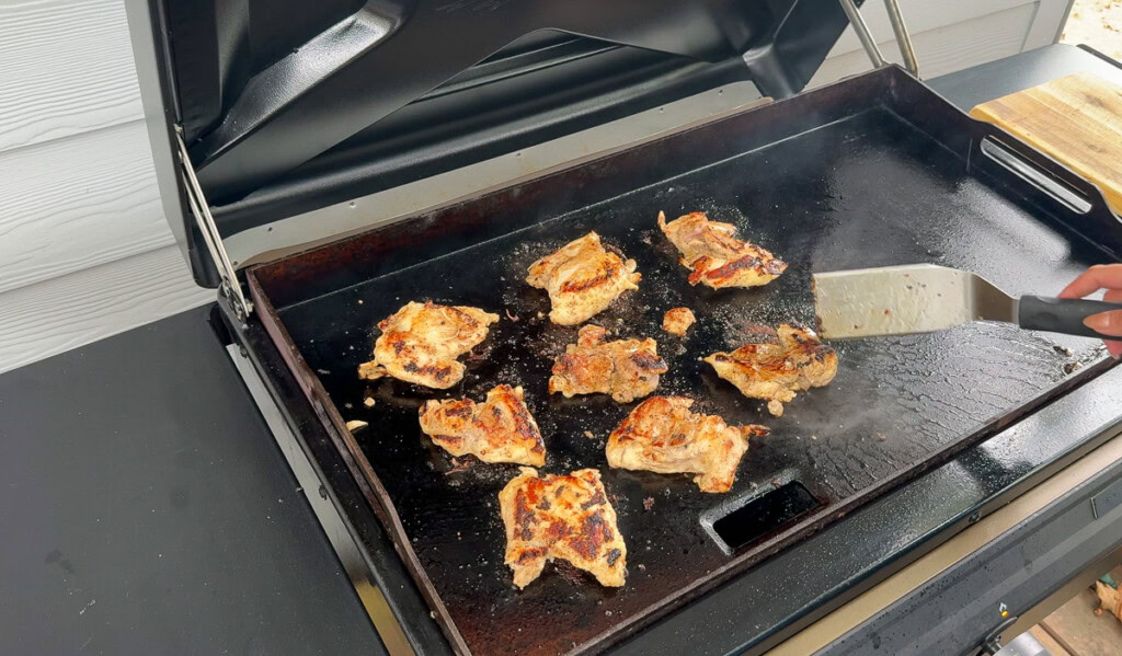 chicken thighs cooking on the griddle