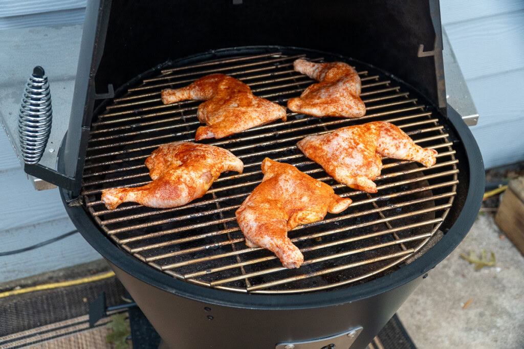 raw chicken on the grilla grills smoker