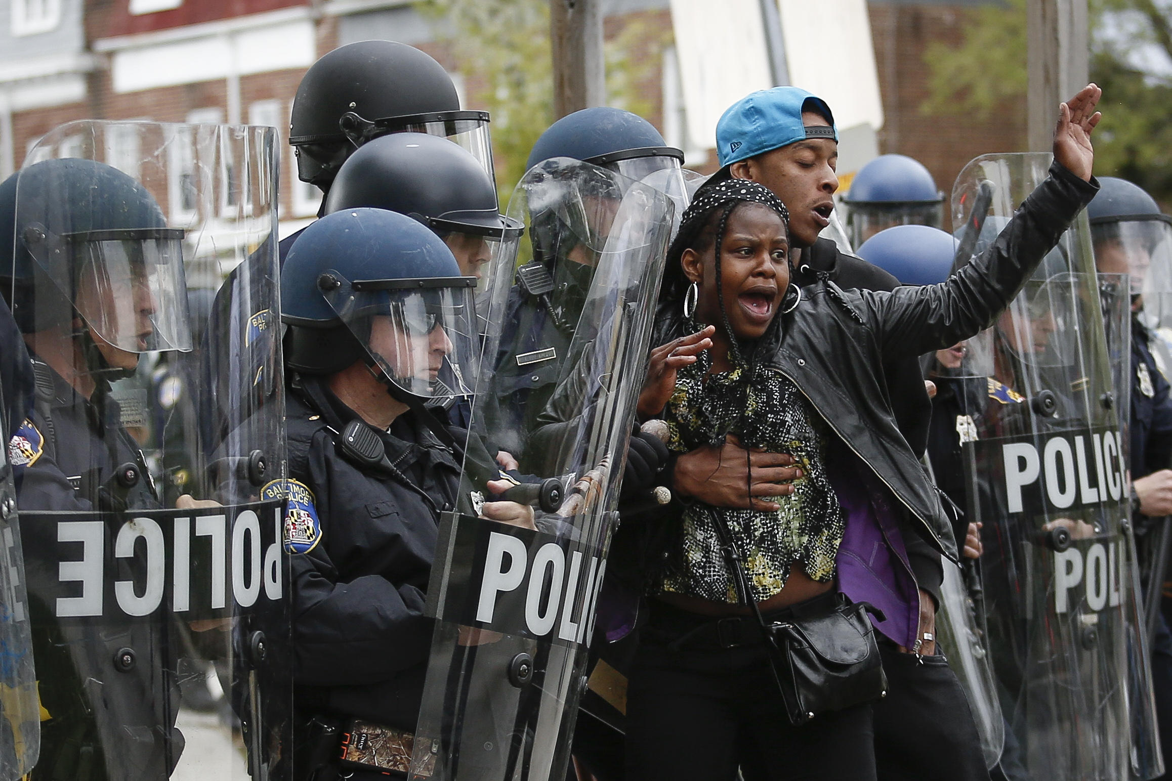 Woman Held Back By Man At Protest