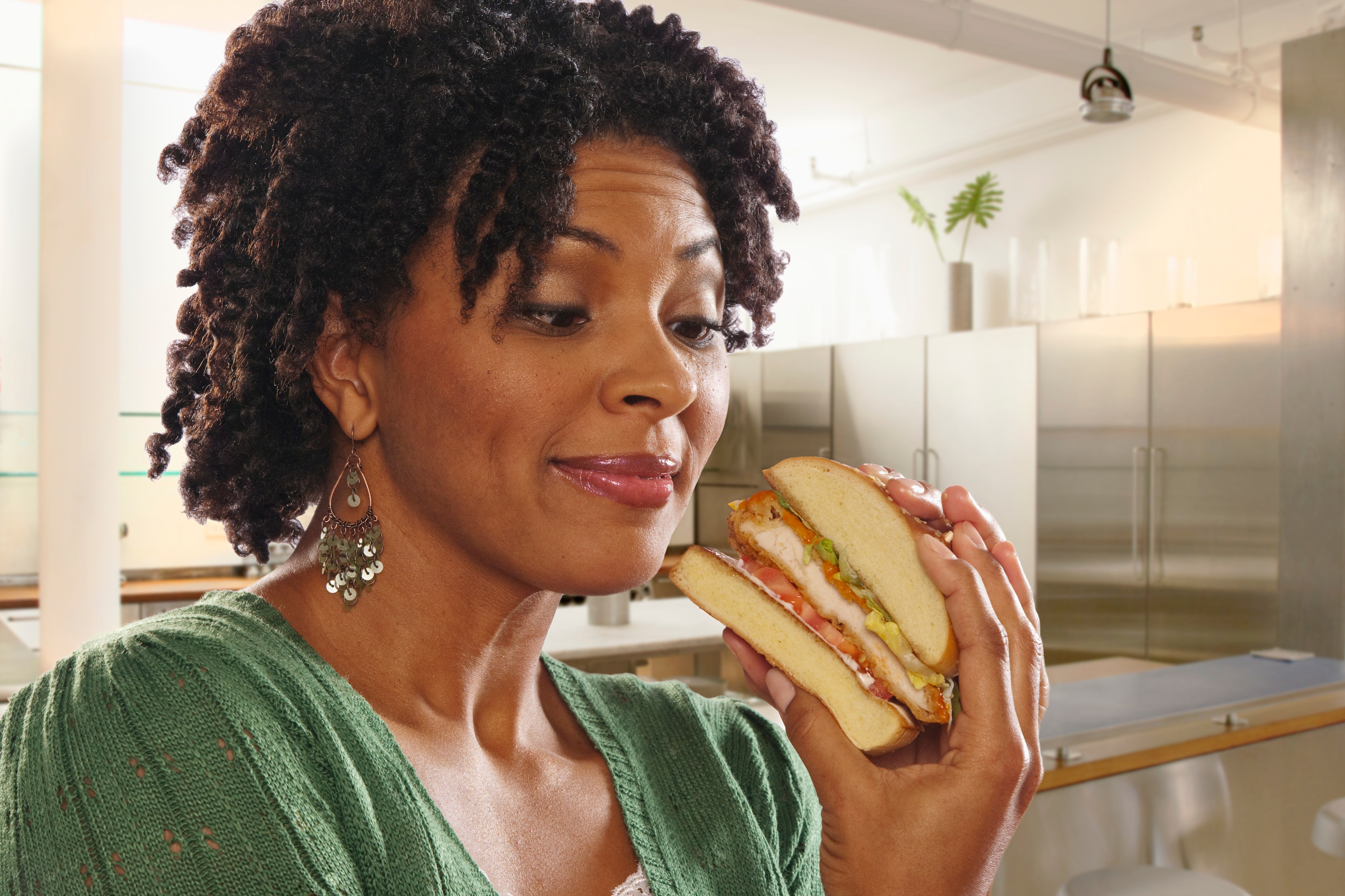 African American woman eating sandwich
