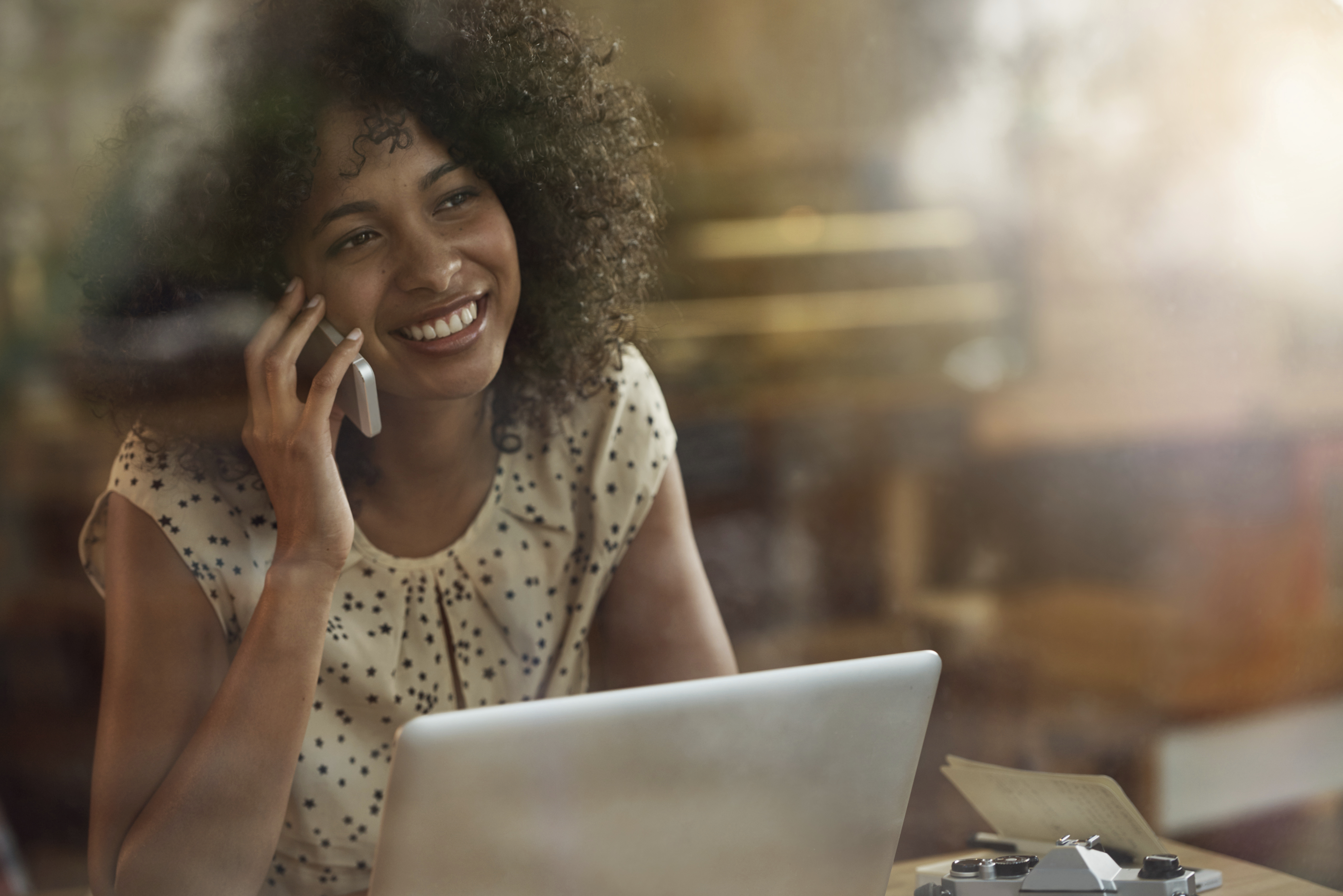 Black woman on phone & computer