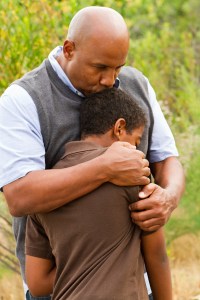 Father comforting his son