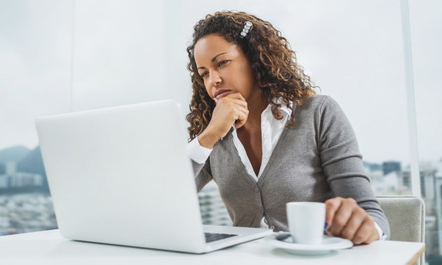 Pensive African American businesswoman using computer at office.