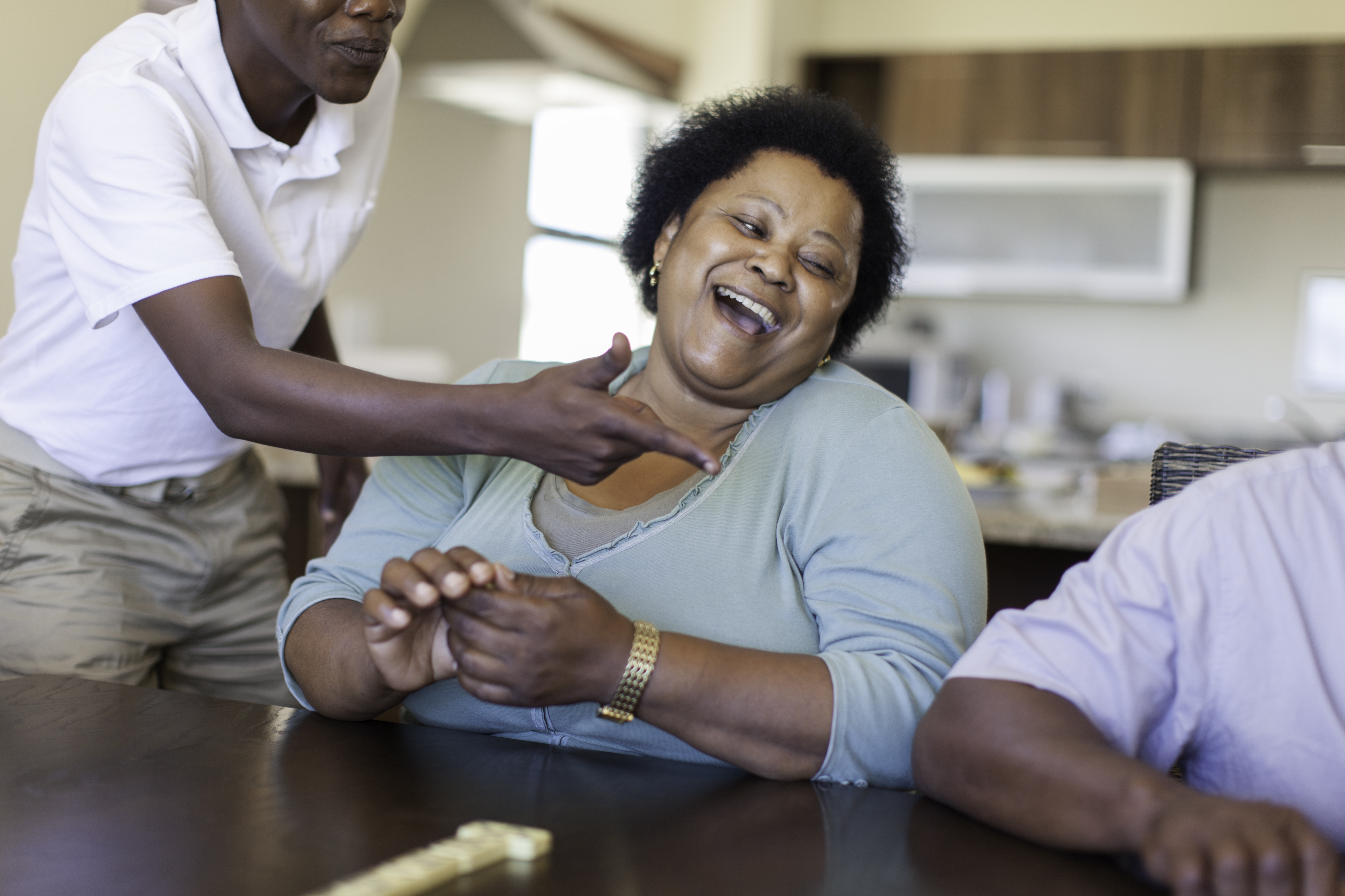 Grandma playing dominoes with your teenage cousins