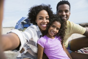Portrait smiling family on beach
