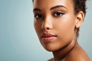 Portrait of young woman on blue background