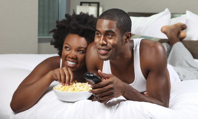 African American Couple Watching a Movie at Home