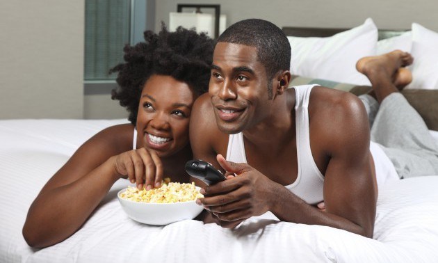 African American Couple Watching a Movie at Home