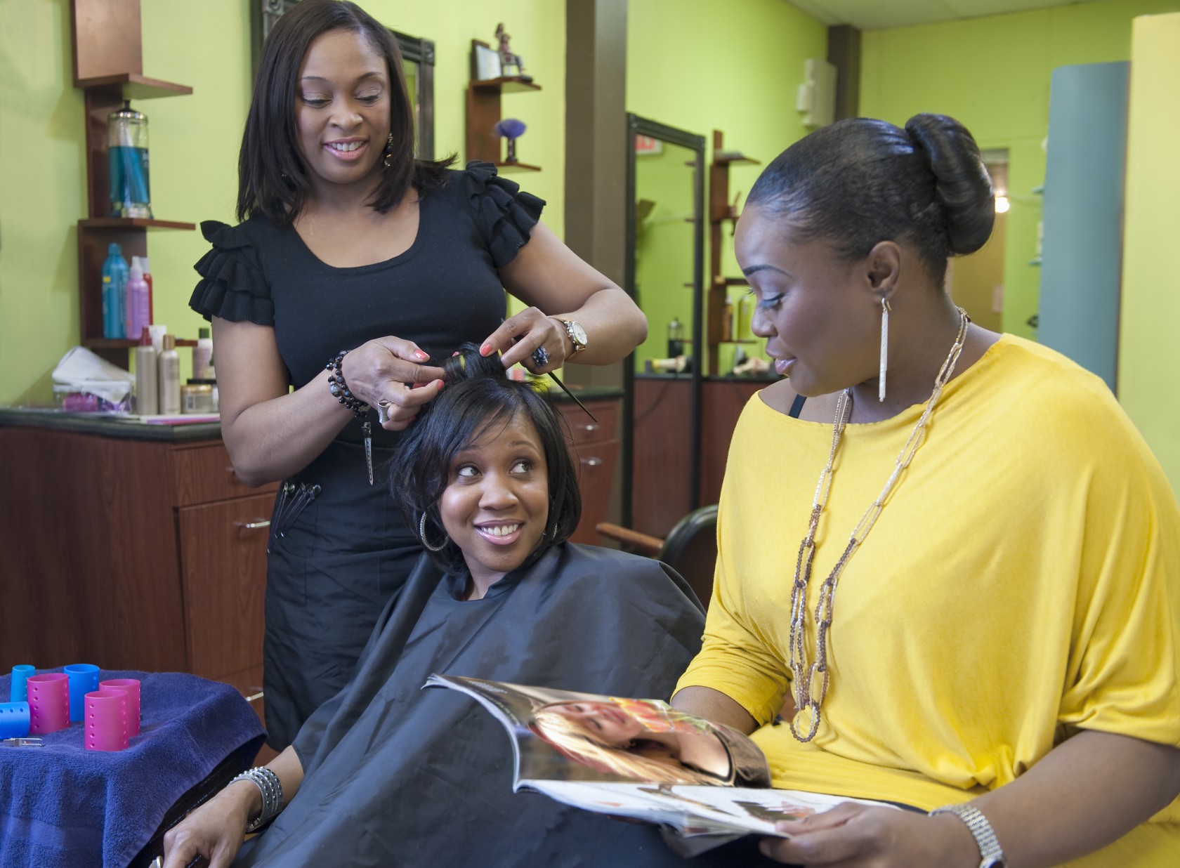 Woman with friend getting hair done at salon