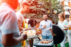Young People Having Fun At Barbecue Party.