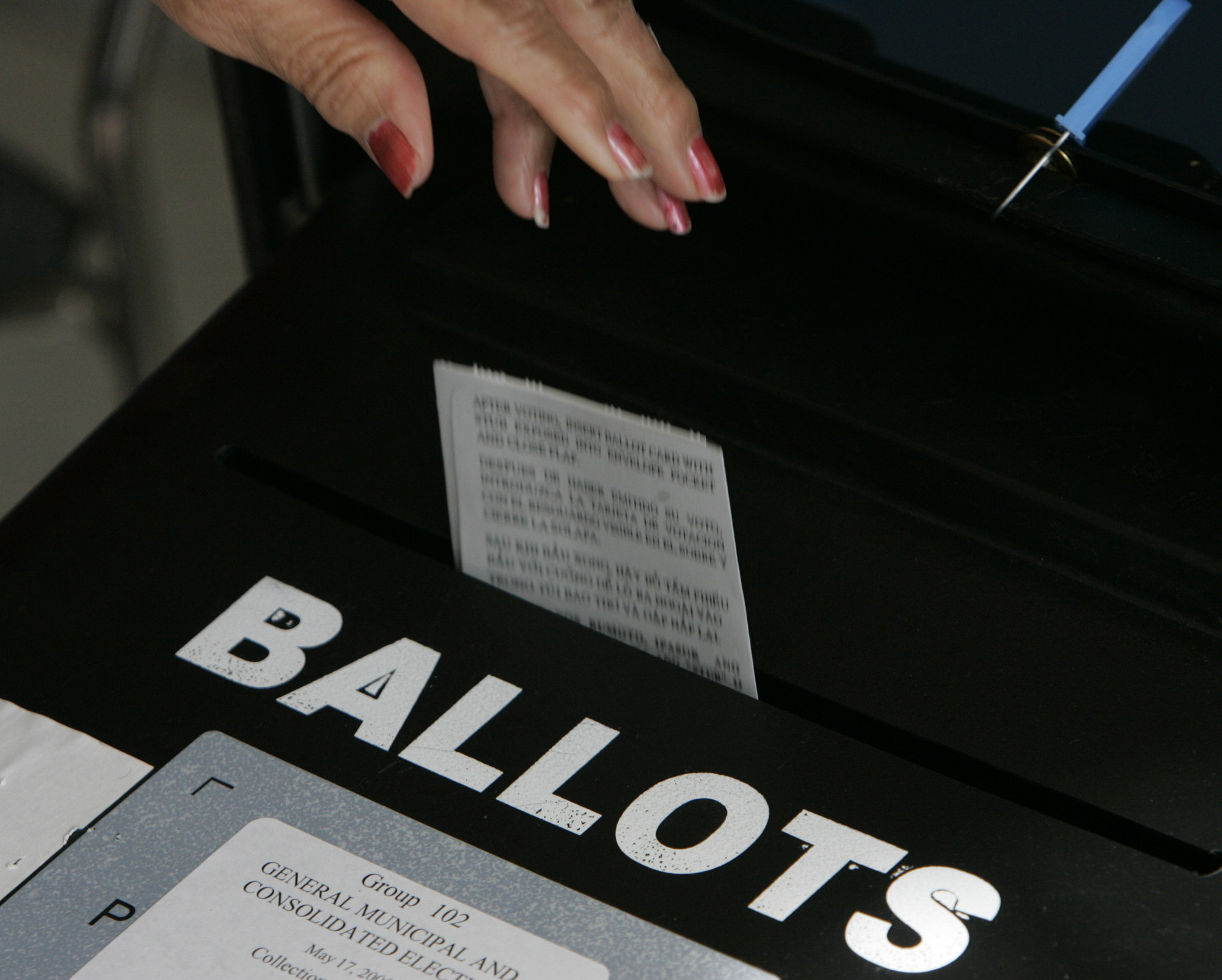 (Los Angeles)Precinct workers drop ballots into the ballot box at the PicoAliso Social Hall polli