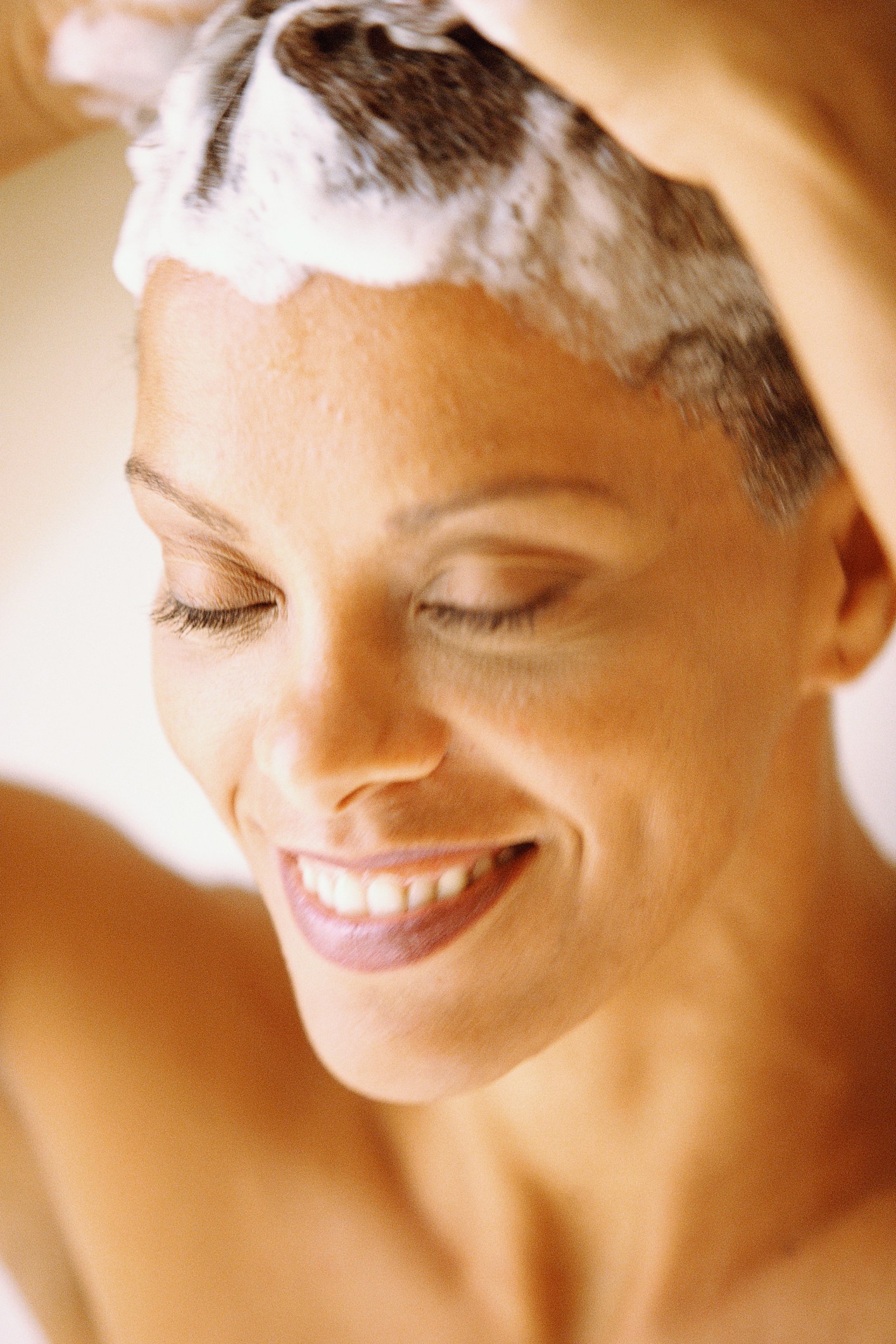 Woman shampooing hair