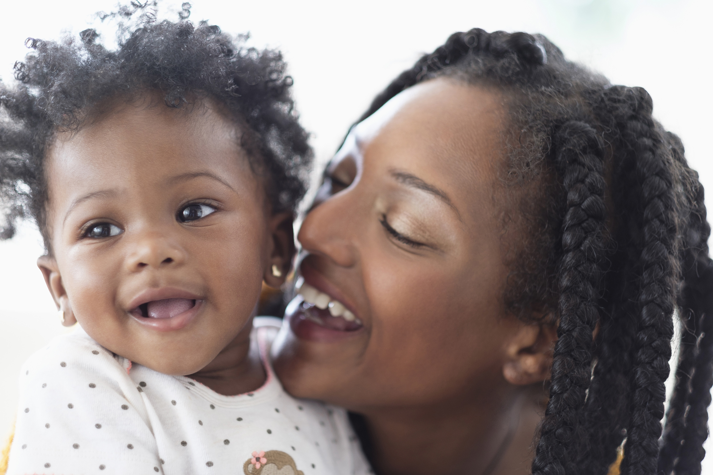 Close of smiling Black woman and baby daughter