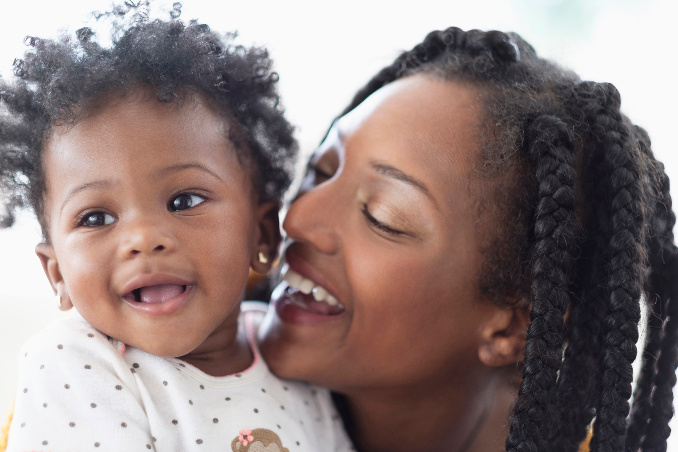 Close of smiling Black woman and baby daughter