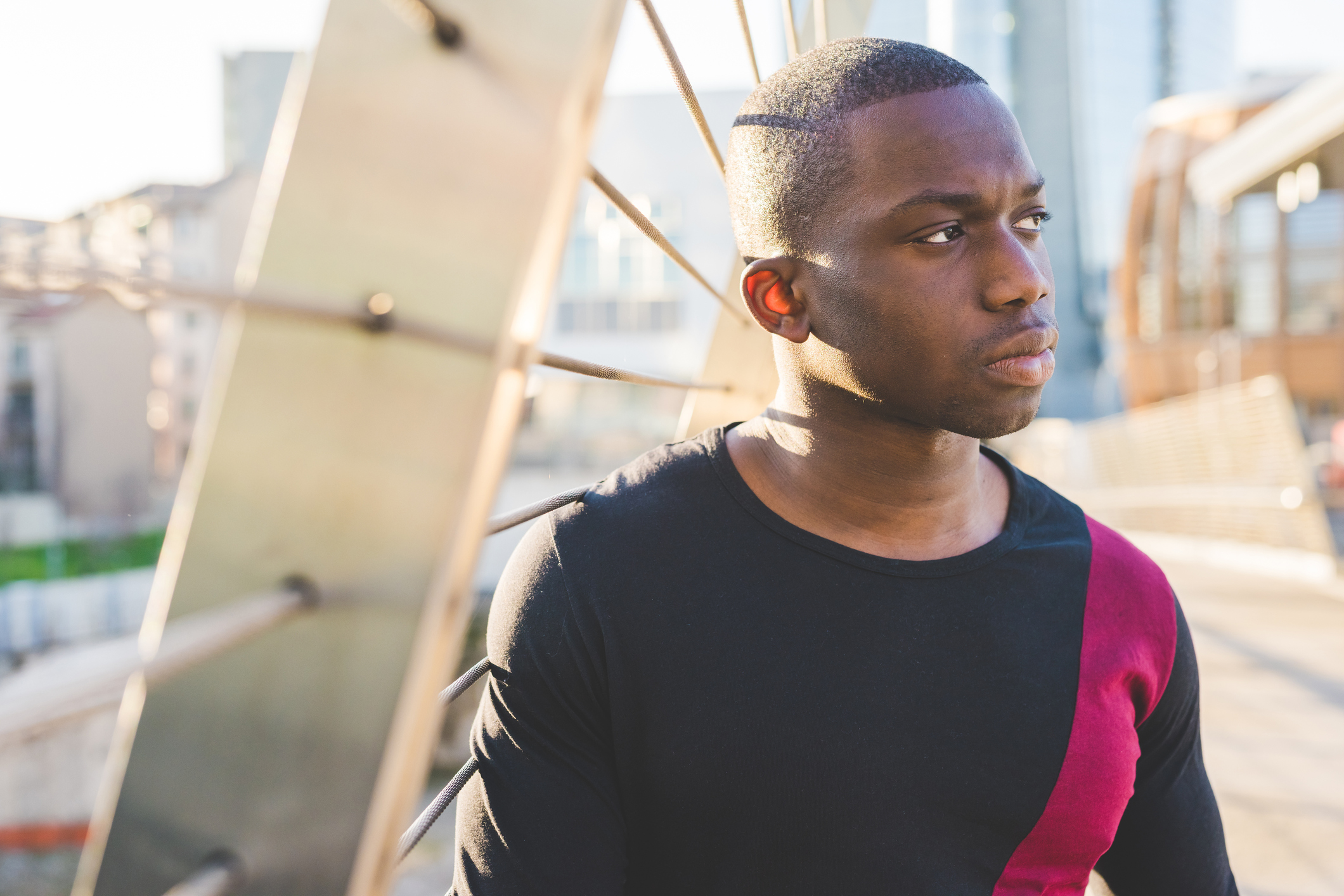 Young man standing on footbridge, looking at view